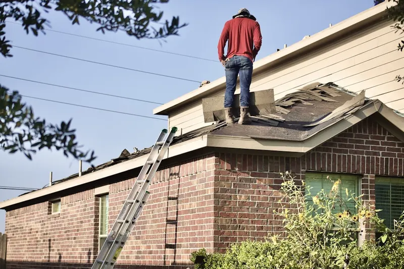 Professional roofer working on a residential roof in Washington Depot